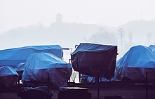 Several boats wrapped in tarpaulins.jpg